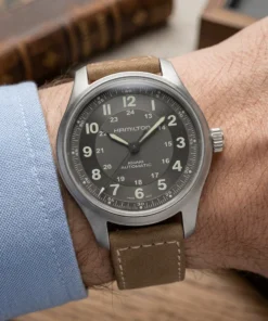 Reloj Hamilton Khaki Field Titanium Auto H70545550 de 42 mm visto en perspectiva con correa de cuero marrón