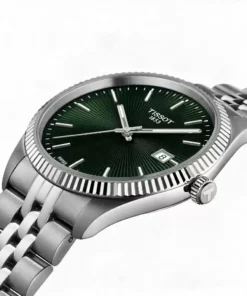 Primer plano de la esfera verde, el bisel trabajado y la corona del Tissot Ballade 40 mm.