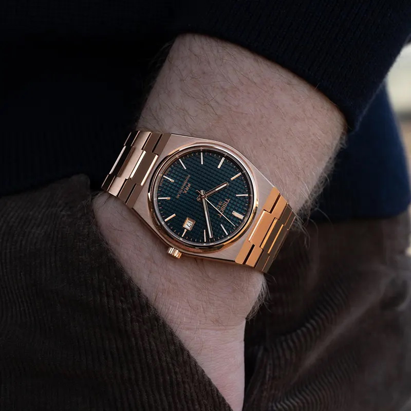 Tissot PRX Powermatic 80 de 40 mm con esfera azul y malla color oro rosa puesto en la muñeca
